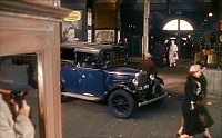 Film: Mrs Wilberforce takes the trunk of stolen money out to a taxi in front of the station